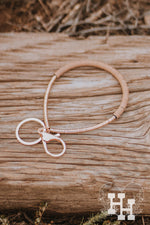 Thin Gold bracelet key chain. Half the braclet has flat thin gold beads and the other half is thin flat light brown beads.